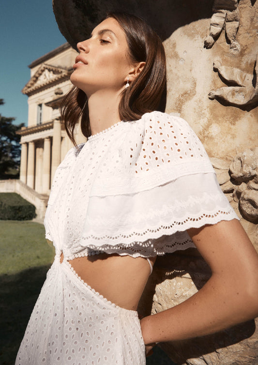 MAIA BERGMAN The Caro dress is back and better than ever! Our most beloved style, this stunning dress features puff sleeves, waist cut-outs, and a laced open back. Made in cotton eyelet, the Caro dress is sophisticated, modern, and romantic, all rolled into one. Perfect for summer events and beyond, this dress is truly a hero.