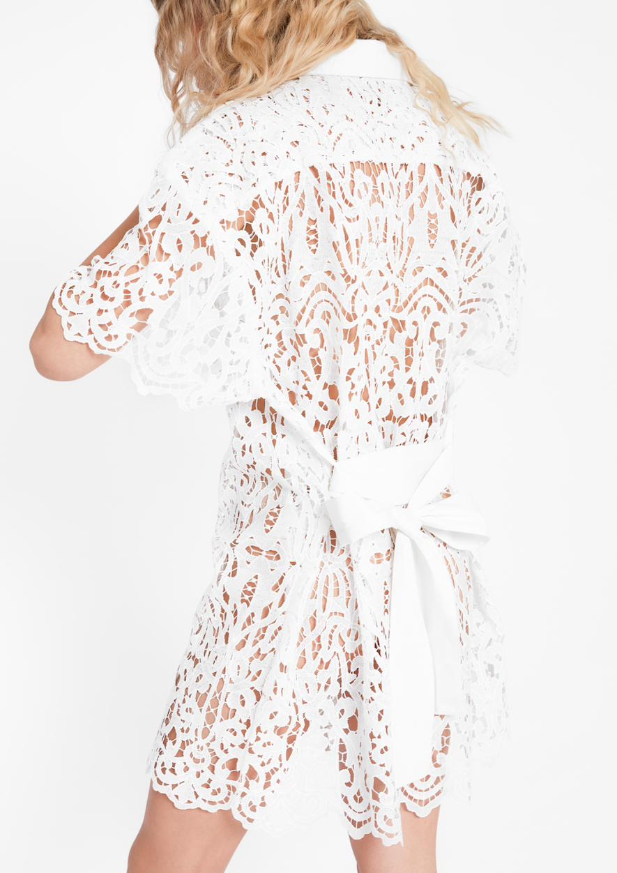 MAIA BERGMAN Introducing the Ida button-down mini dress - your new favorite go-to dress! This dress is made from stunning lace guipure and is perfect for any occasion. Its versatile design makes it great to wear with trousers or as a stand-alone piece. Wear it with a slip underneath, or even a tank and a pair of jeans. Absolutely perfect as an elevated beach cover-up!